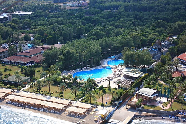 A resort pool beside a sandy beach area, illustrative of a residential crystal lagoon