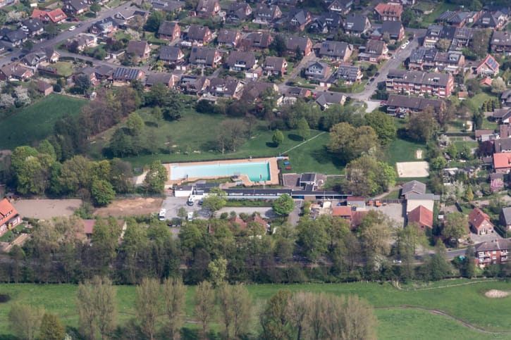 A large public outdoor pool, illustrative of a busy water park