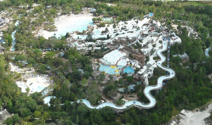 Aerial view of a large water park pool, illustrative of a resort fun lagoon